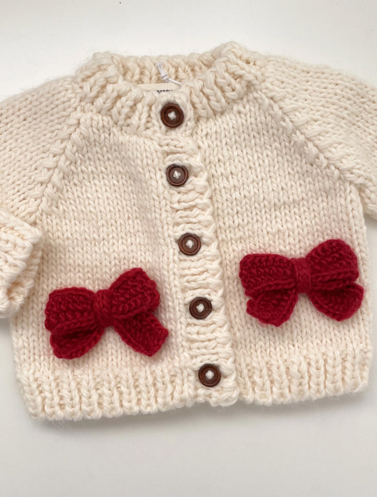 Red Bow Cardigan in Cream flat lay image.