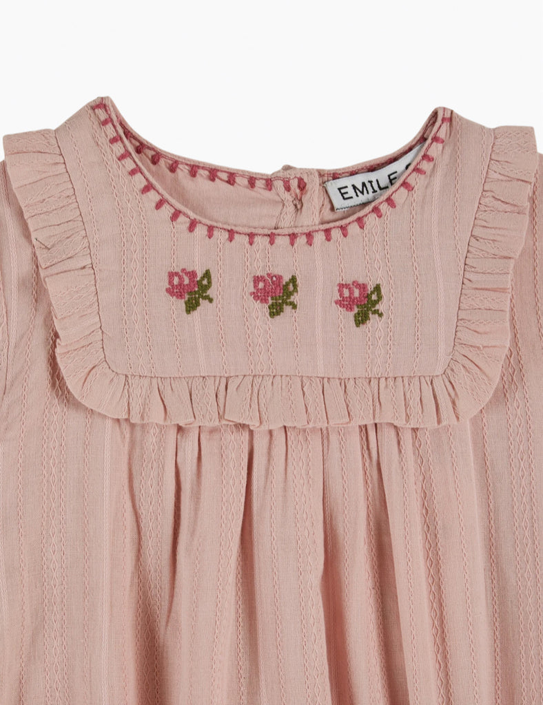 Pink dress with embroidered details and 'Emile' brand label on a white background