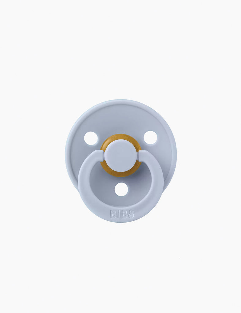 Baby pacifier with a gold center on a white background