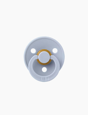 Baby pacifier with a gold center on a white background