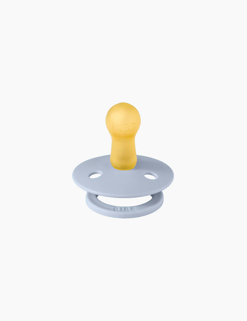 Yellow and light blue pacifier on a white background