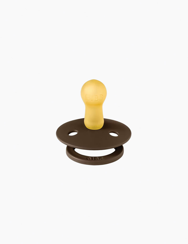 Brown and yellow pacifier on a white background