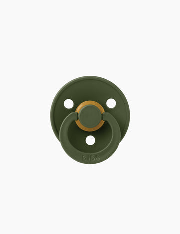 Green baby pacifier on a white background