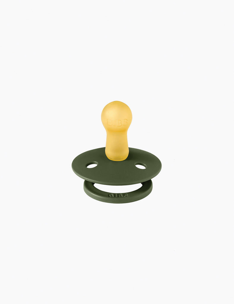 Green and yellow pacifier on a white background