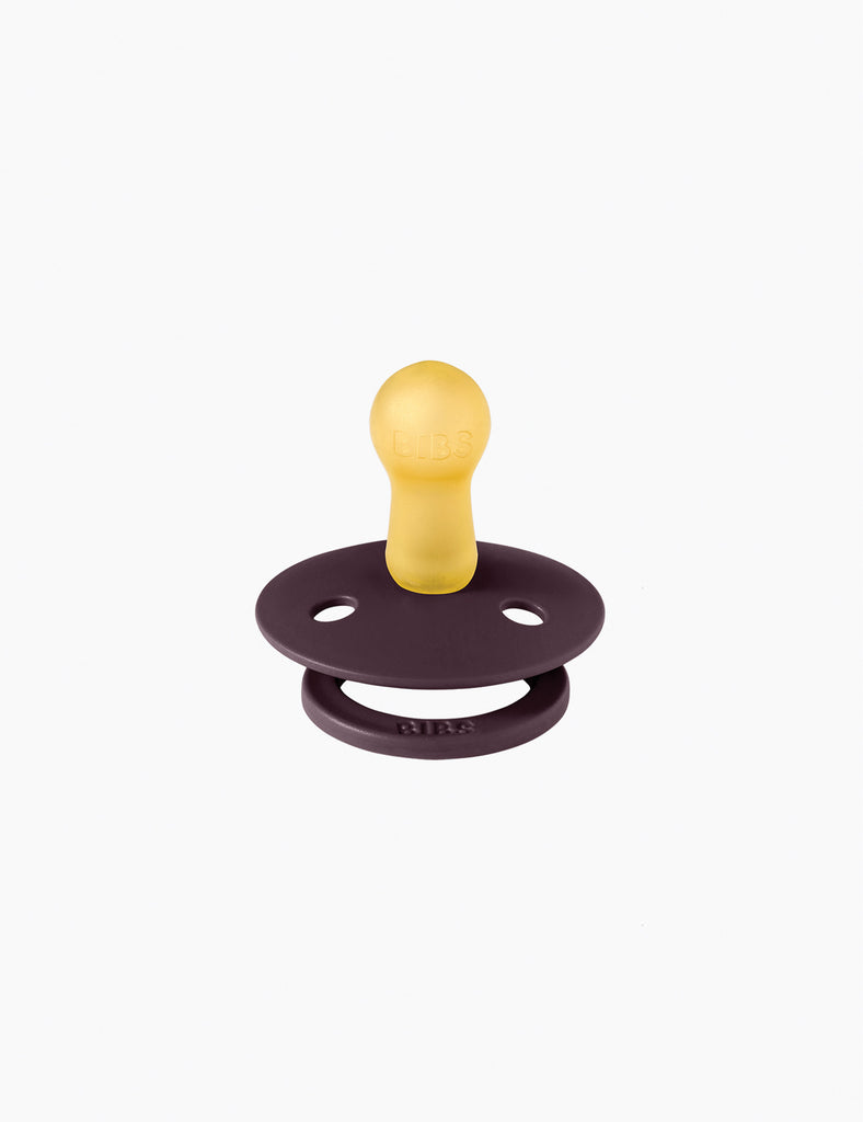 Yellow and brown pacifier on a white background