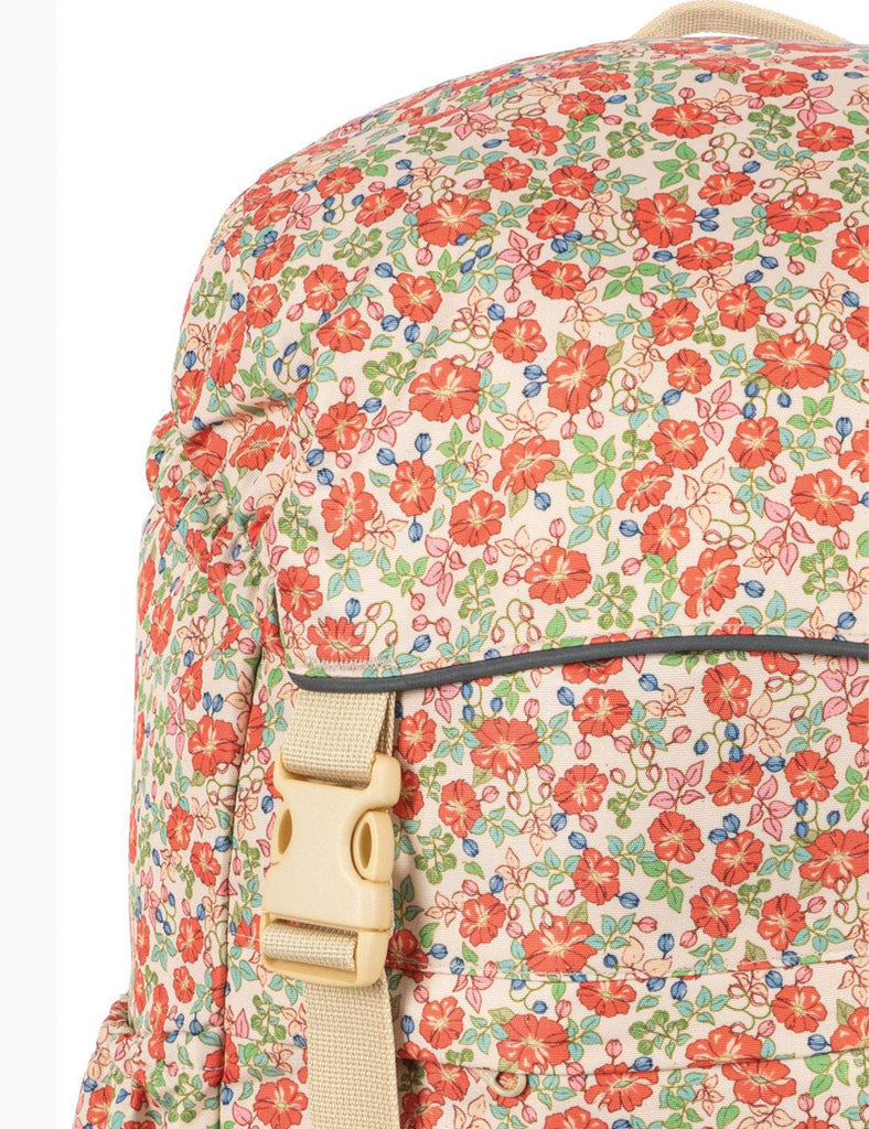 Floral-patterned backpack with a beige buckle on a white background