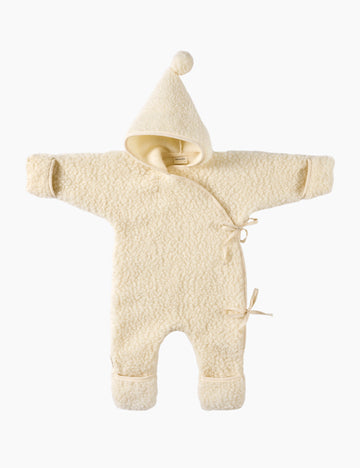 Cream-colored baby snowsuit with hood on a white background