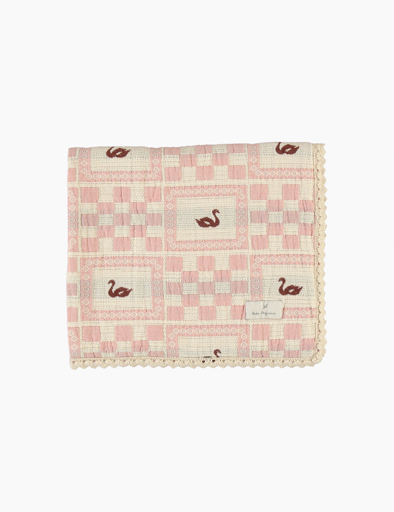 Pink checkered blanket with swan pattern on a white background