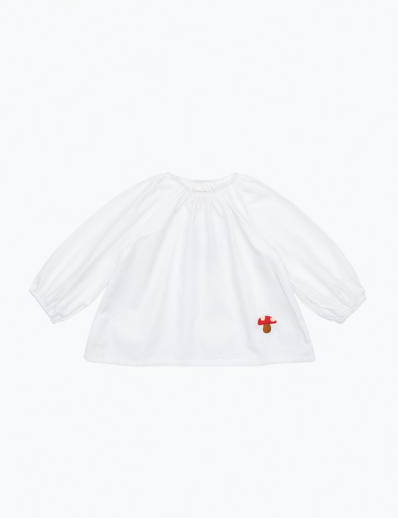 White blouse with a small red mushroom on a white background