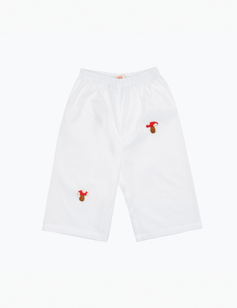 Image of white baby pants with embroidered red and white mushrooms on a white background.