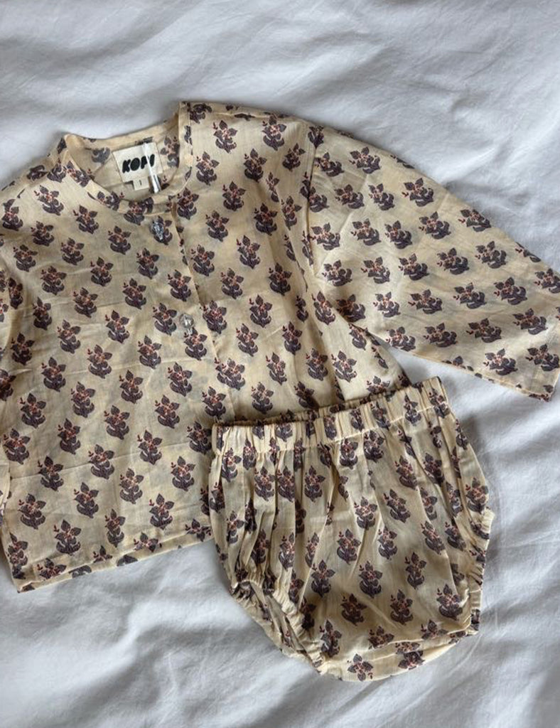 Floral patterned pajama set on a white bedspread