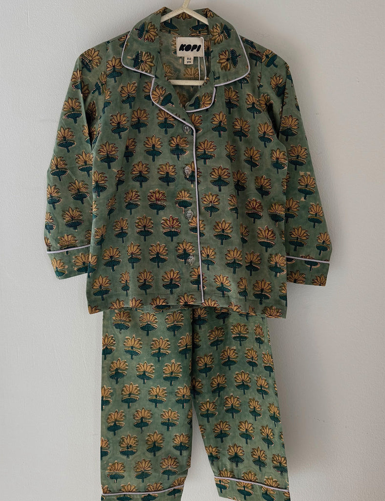 Patterned pajama set on a hanger against a white background