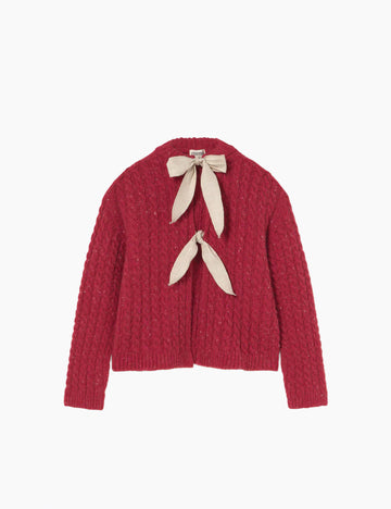 Red knitted cardigan with beige ribbon on a white background
