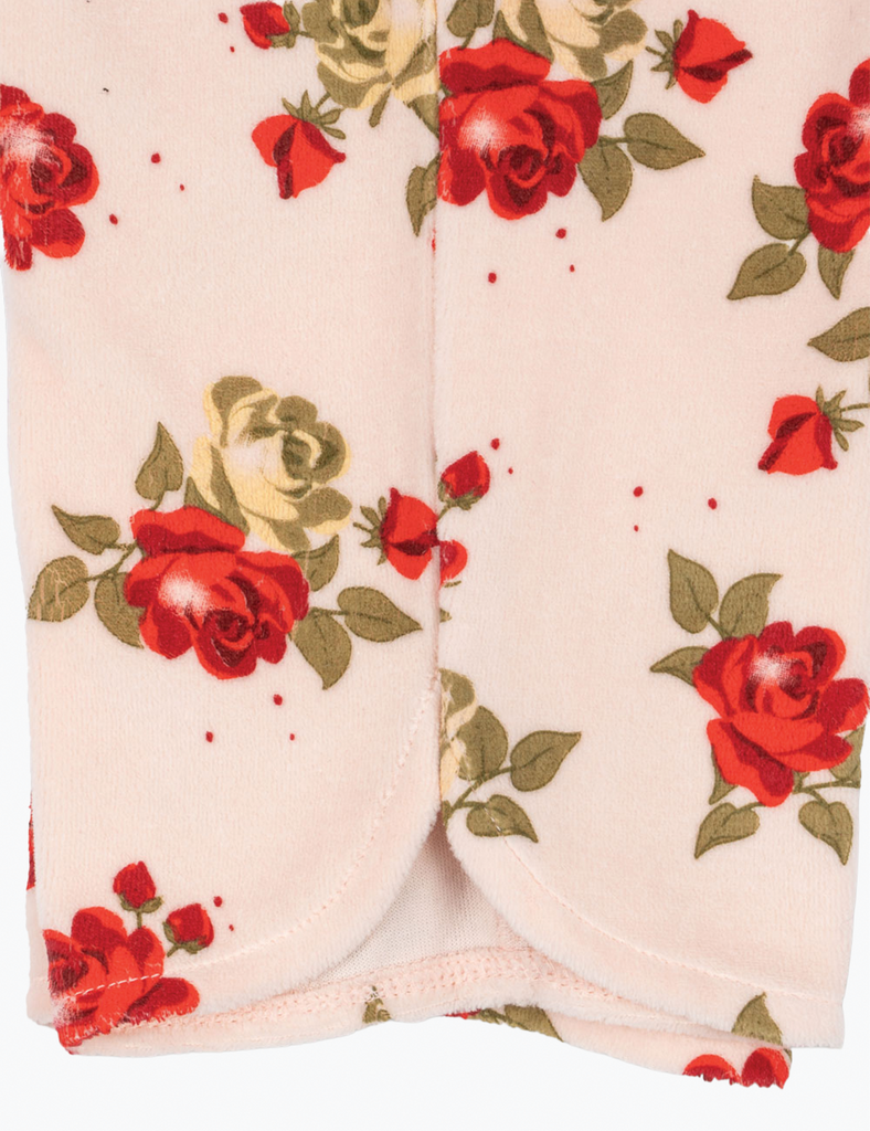 Close-up of a garment with red rose floral pattern on a white background