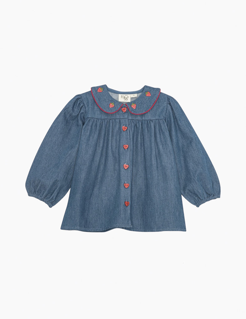 Blue denim top with red strawberry accents on a white background