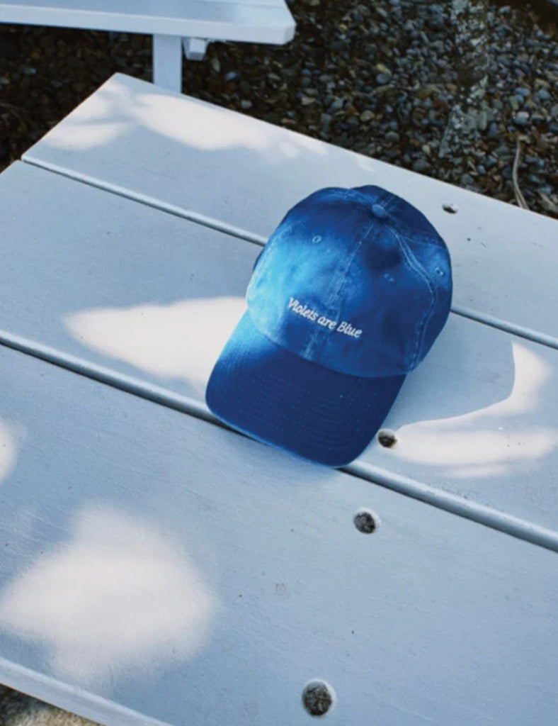 Blue cap with text on a light gray surface