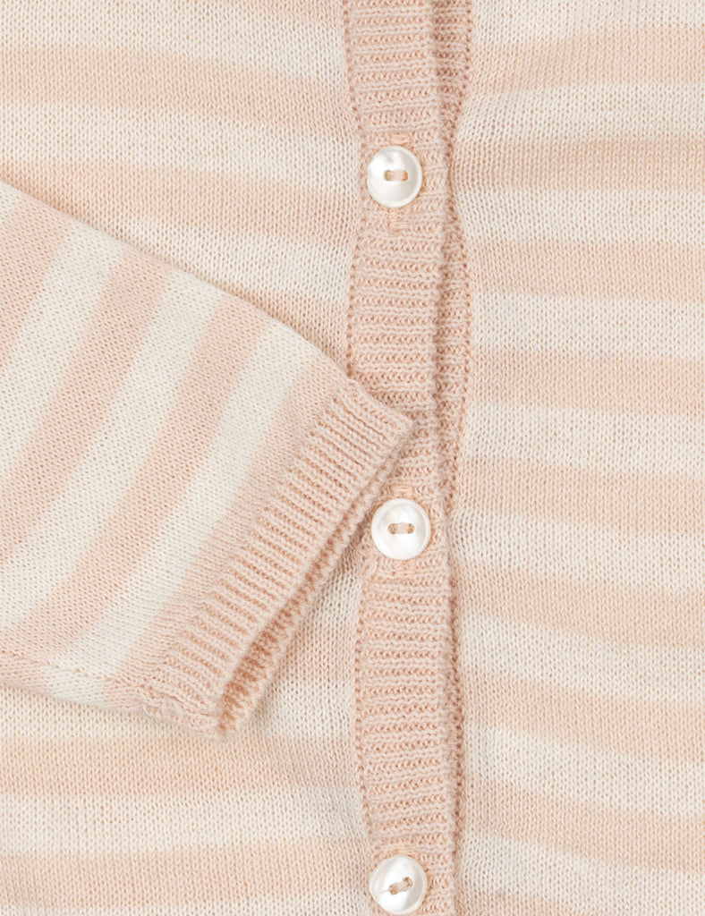 Close up of striped baby cardigan on a white background.