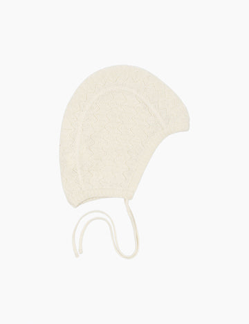 Cream-colored baby bonnet on a white background