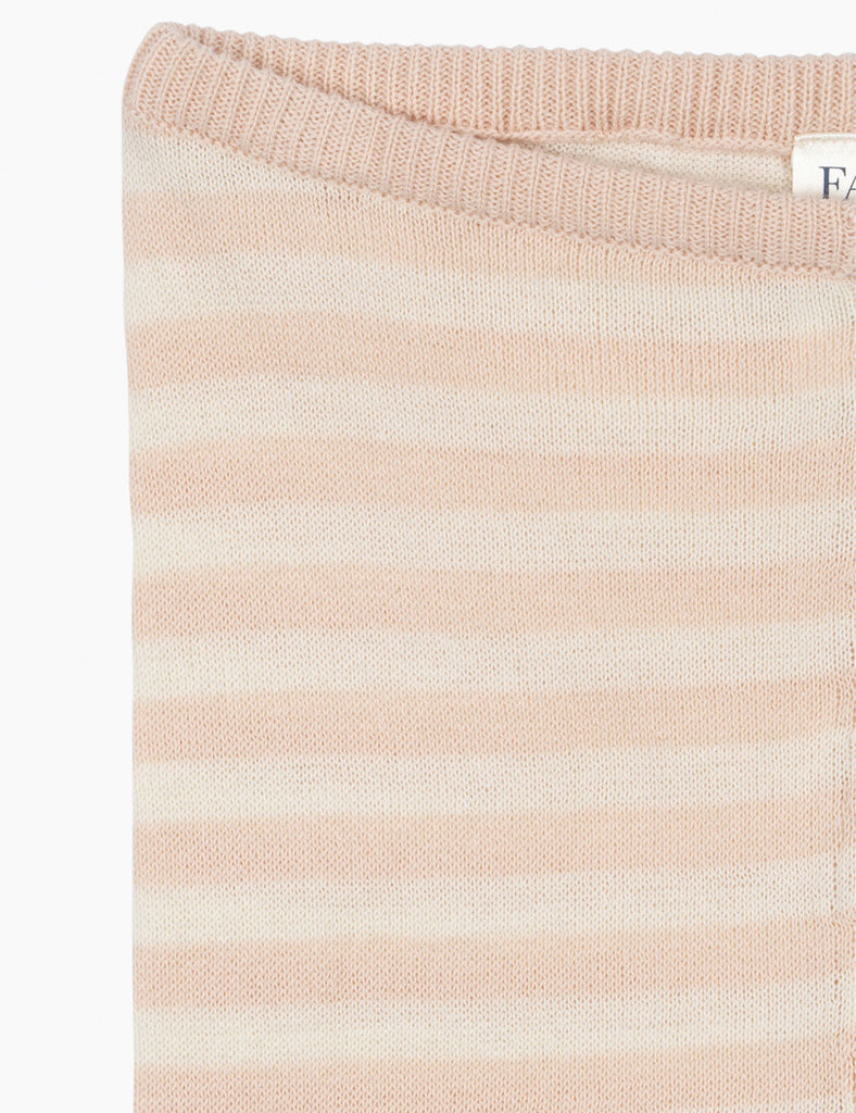 Close-up of a pink and white striped fabric with a brand label.