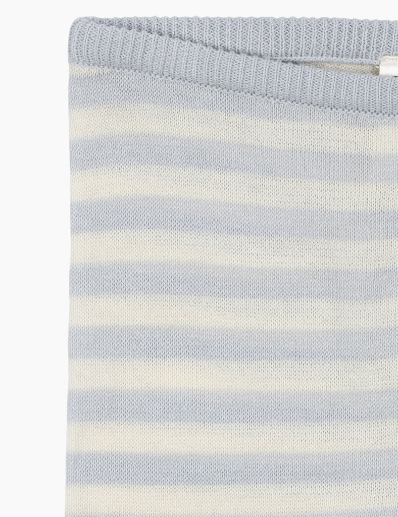 Close-up of a blue and white striped fabric with a tag on a white background