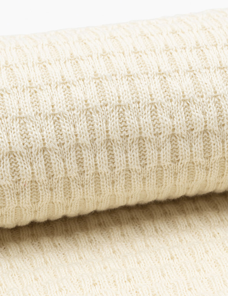 Close-up of beige knitted baby blanket