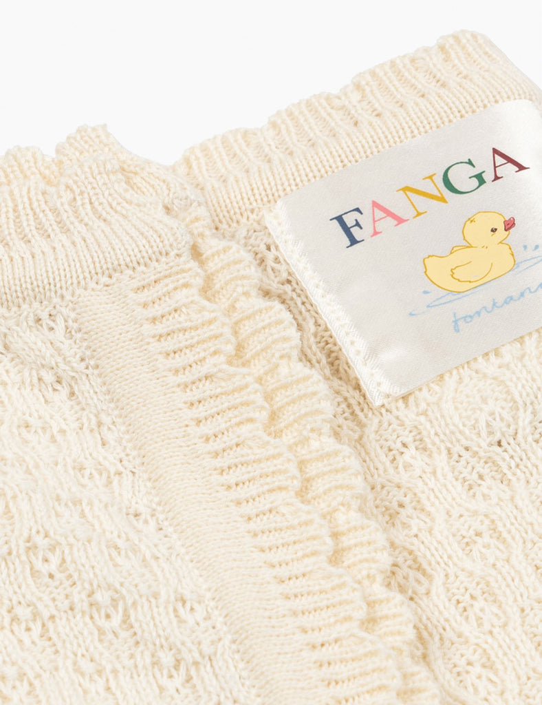 Close up of the pointelle knitted baby blanket with Fanga branding.