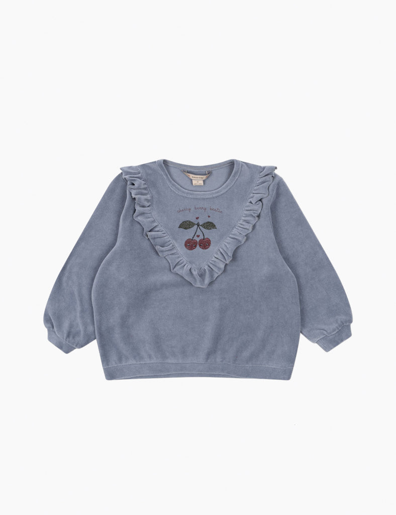 Blue sweater with ruffled collar and cherry design on a white background