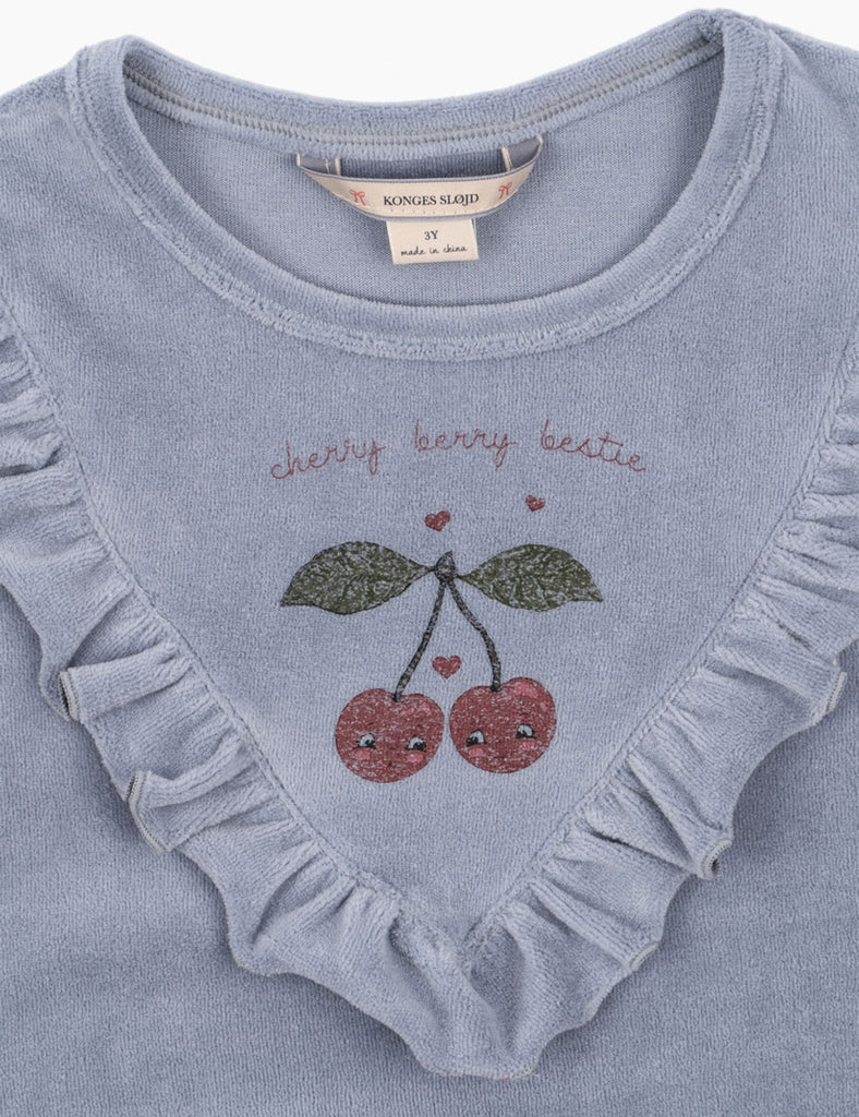 Blue baby romper with cherry design and text on a light blue background