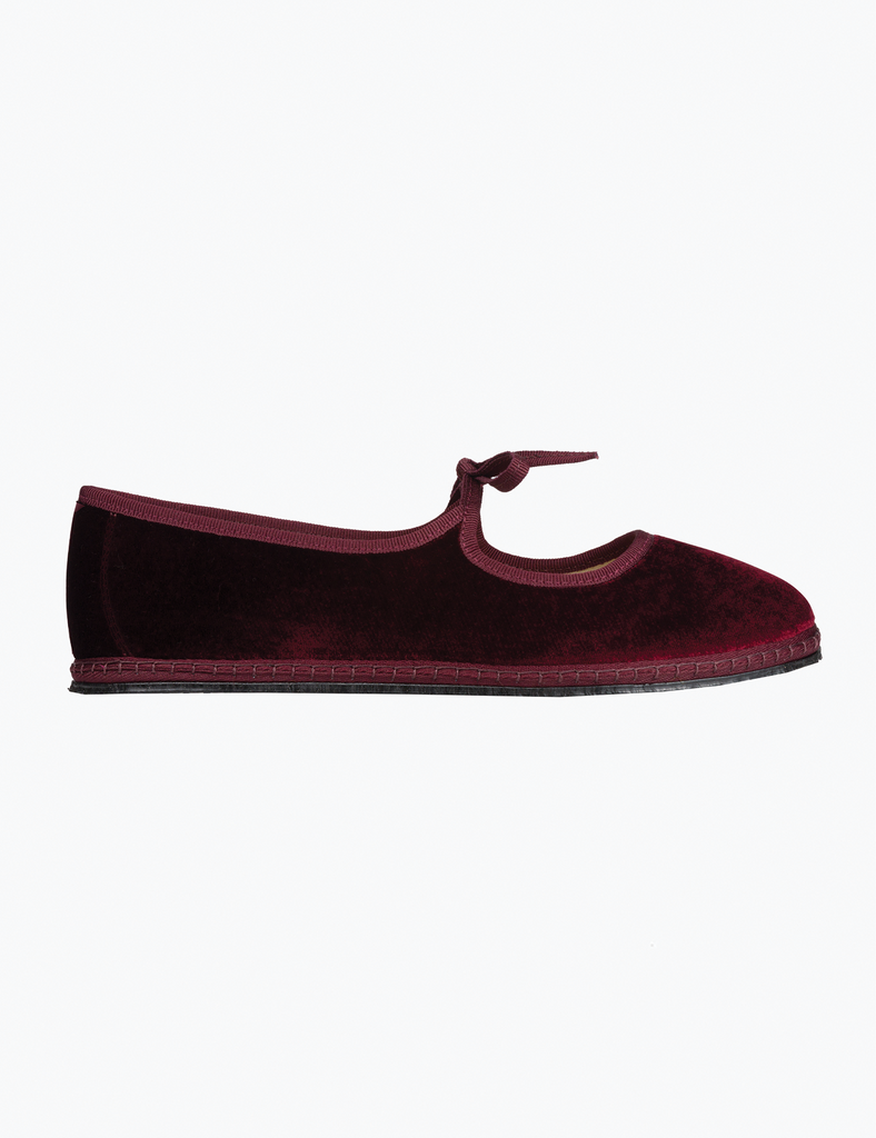 Burgundy slipper shoe on a white background