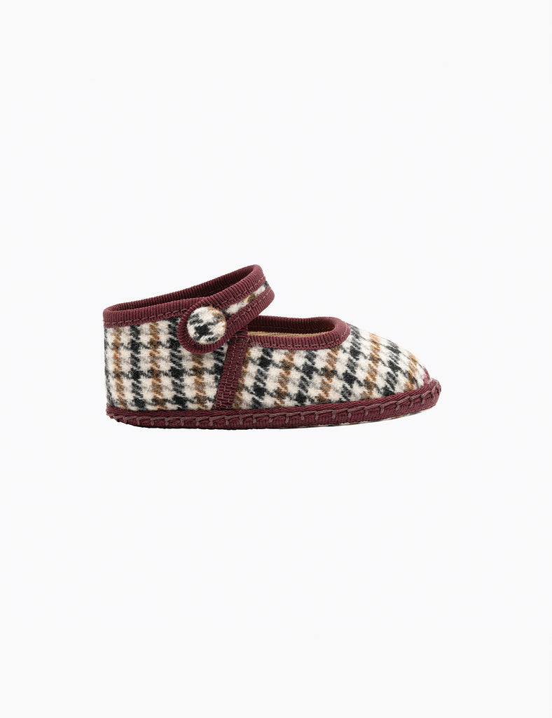Plaid baby shoe with brown trim on a white background