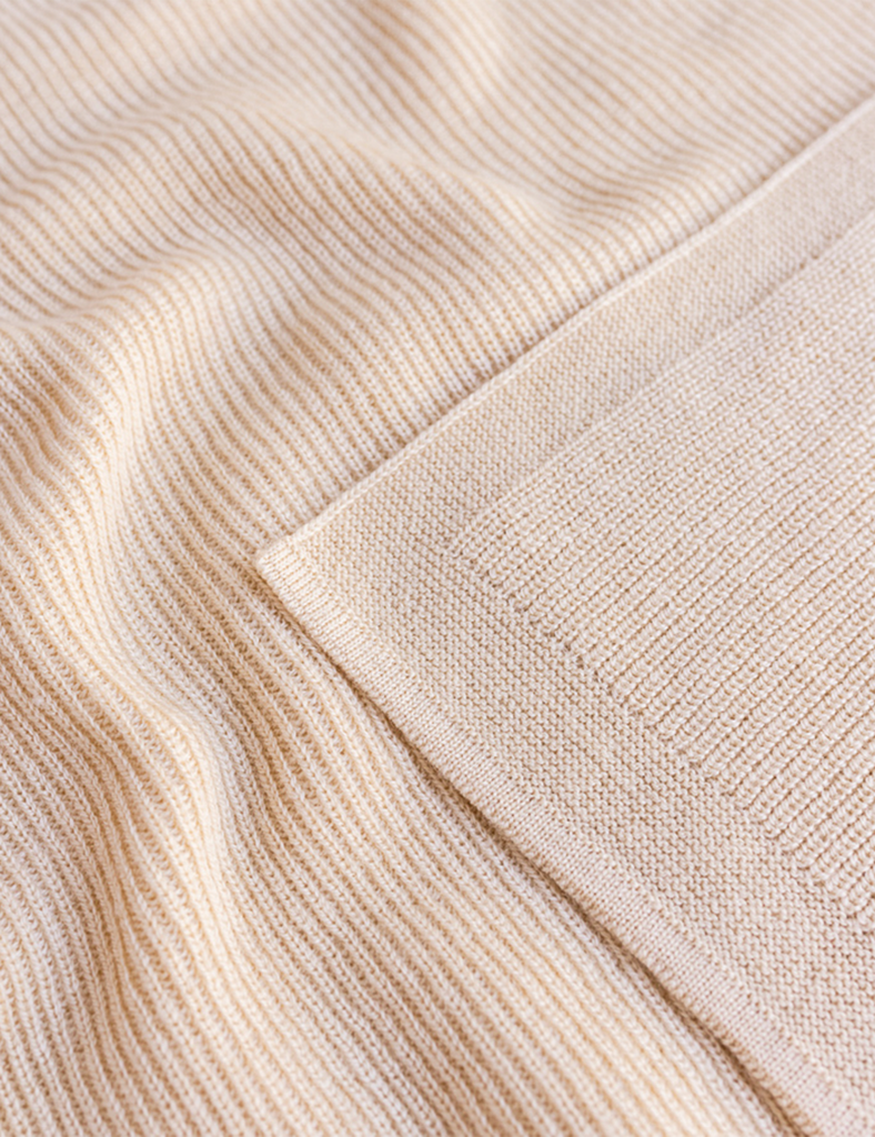 Close-up of beige fabric with a textured pattern
