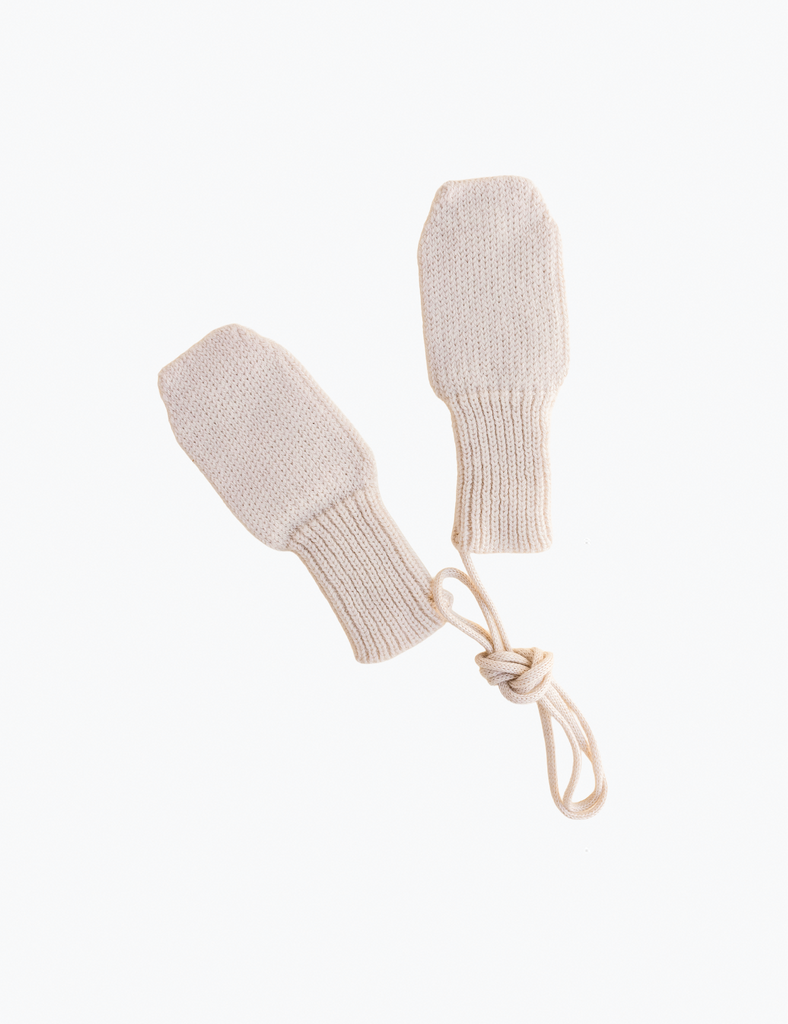 image of cream knitted mittens on a white background.